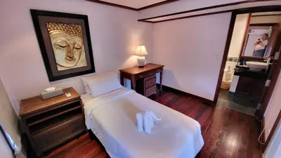 a hotel room with a bed and a mirror at Villa Mauao - Luxury Villa in Katamanda, Kata in Kata Beach
