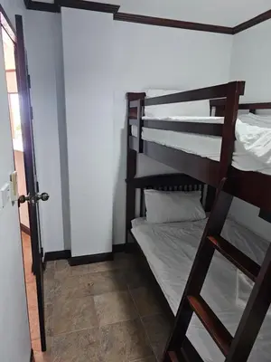 a room with two bunk beds and a door at Sai Rougn apartment in Patong Beach