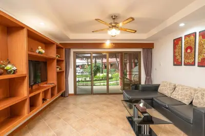 a living room with a couch and a television at Sai Rougn apartment in Patong Beach