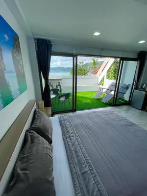 a bedroom with a bed and a view of the ocean at Apartment Sea View Patong Beach in Patong Beach