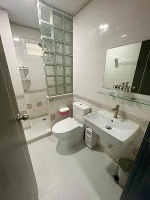 a bathroom with a white toilet and a sink at Apartment Sea View Patong Beach in Patong Beach