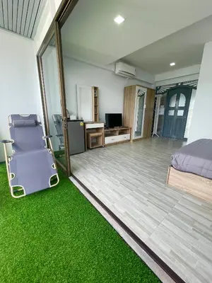 a bedroom with green carpet and a bed and a desk at Apartment Sea View Patong Beach in Patong Beach