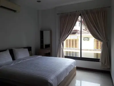 a bedroom with a bed and a large window at 4BD Private pool villa in Patong heart quiet&nice in Patong Beach