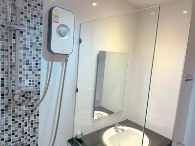 a bathroom with a sink and a mirror at Ahad Suite Aonang in Ao Nang Beach