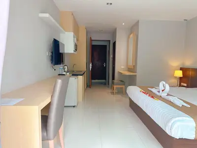 a room with a bed and a kitchen with a table at Ahad Suite Aonang in Ao Nang Beach