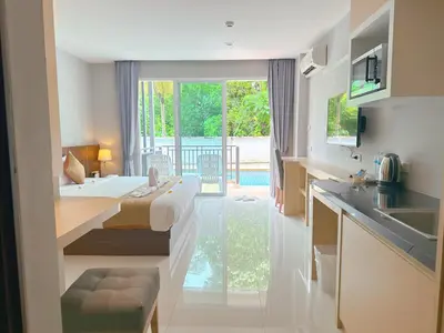 a kitchen with a bed and a sink in a room at Ahad Suite Aonang in Ao Nang Beach