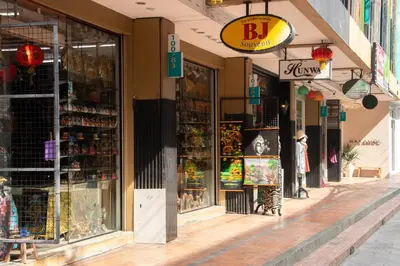 a store front of a shopping street with shops at The Blue Pearl Kata Hotel in Kata Beach