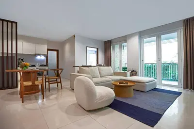 a living room with a couch and a table at Surin Park by Destada in Surin Beach