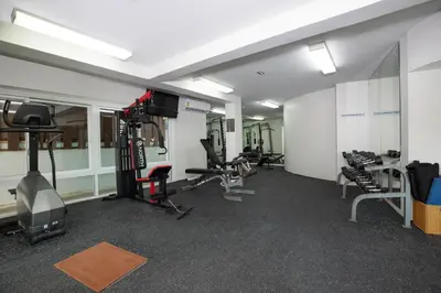 a gym with several treadmills and exercise bikes at Surin Park by Destada in Surin Beach