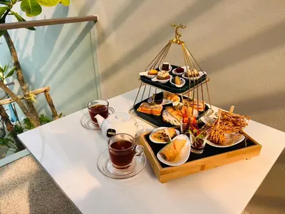 a table with a tray of food on a table at Phuket Emerald Beach Resort in Karon Beach