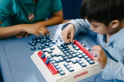 a young boy playing with a lego game at Phuket Emerald Beach Resort in Karon Beach