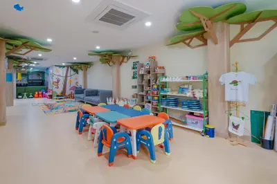 a classroom with a table and chairs in a room at Phuket Emerald Beach Resort in Karon Beach