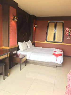 a bedroom with a bed and a desk and a bed sidx sidx sidx at 99 Residence in Patong Beach