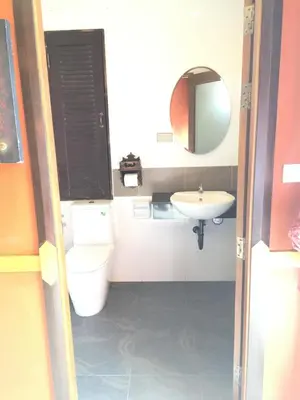 a small bathroom with a toilet and a sink at 99 Residence in Patong Beach