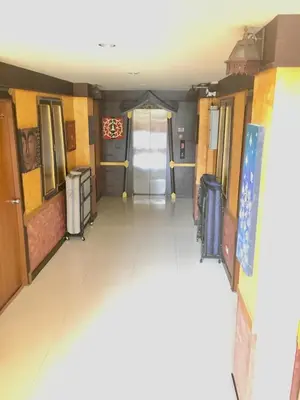 a hallway in a building with a door and a floor at 99 Residence in Patong Beach
