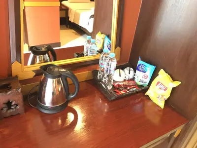 a table with a coffee pot and a mirror at 99 Residence in Patong Beach