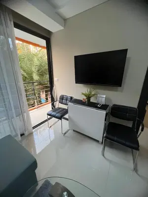 a living room with a flat screen tv on the wall at Apartments MBC 1308 in Mai Khao Beach