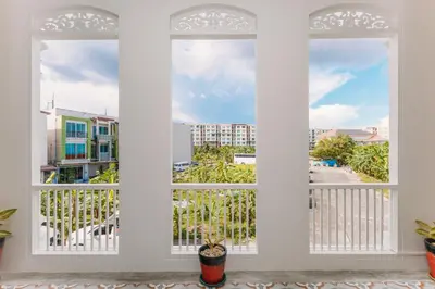 a view from the living room of a balcony with two windows at Botan Boutique Hotel in Patong Beach