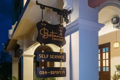 a sign that says self service on the side of a building at Botan Boutique Hotel in Patong Beach