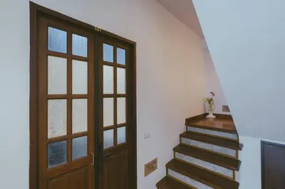 a stairway with a wooden door and a stair case at Botan Boutique Hotel in Patong Beach