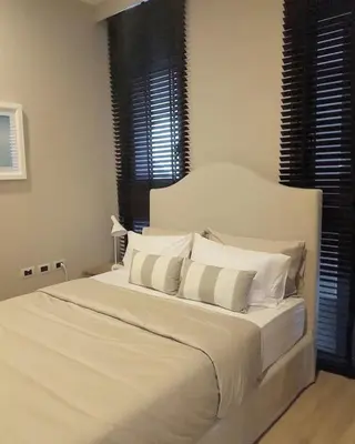 a white bed with white pillows in a bedroom at Baan Maikhao pool villa in Mai Khao Beach