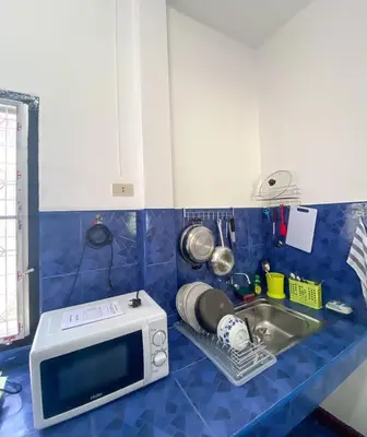 a kitchen counter with a microwave and a sink at Karon House 15C in Karon Beach