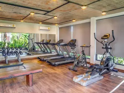 a gym with a row of exercise bikes at Direct pool access 2br apartment @The Title Rawai in Rawai Beach