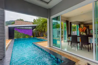 an infinity pool in the backyard of a house at 3 Bedroom Platinum Pool Villa Smooth as Silk in Ban Khlong Haeng