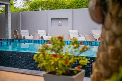a swimming pool with chairs and a poolasteryasteryasteryasteryasteryasteryasteryastery at 3 Bedroom Platinum Pool Villa Smooth as Silk in Ban Khlong Haeng