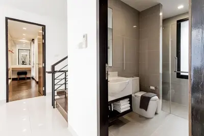 a bathroom with a toilet and a sink and a mirror at Laguna Park Modern Pool Villa in Phuket Town