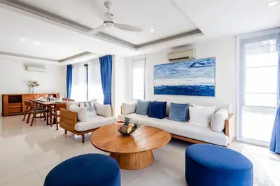 a living room with a couch and a table at Laguna Park Modern Pool Villa in Phuket Town