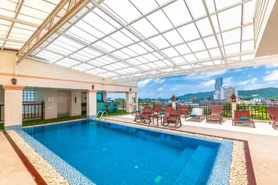 a swimming pool with a view of a building at Patong Heaven in Patong Beach