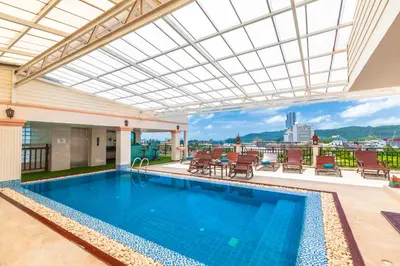 a swimming pool in a building with a view at Patong Heaven in Patong Beach