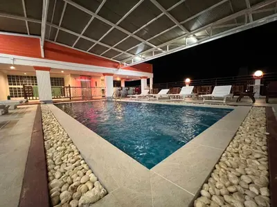 a swimming pool at night with rocks around it at Patong Heaven in Patong Beach