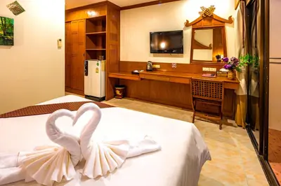 a bedroom with a bed with a heart decoration on it at Patong Heaven in Patong Beach