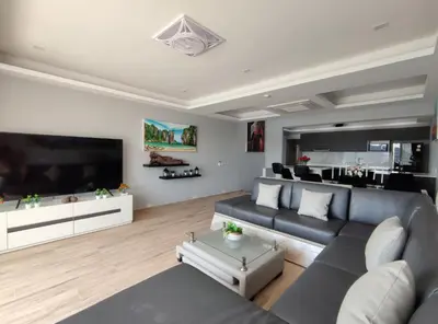 a living room with a couch and a large tv at Sawansa 34A Modern Luxury 3BR Sea View 450m2 in Patong Beach