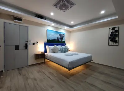 a bedroom with a bed and a painting on the wall at Sawansa 34A Modern Luxury 3BR Sea View 450m2 in Patong Beach
