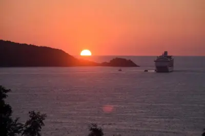 a cruise ship in the ocean at sunset at Sawansa 34A Modern Luxury 3BR Sea View 450m2 in Patong Beach