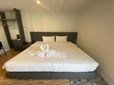 a bedroom with a bed with a flower on it at 77 Patong Hotel & Spa in Patong Beach