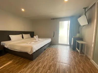 a bedroom with a bed with a bow on it at 77 Patong Hotel & Spa in Patong Beach