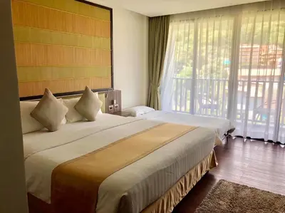 a hotel room with two beds and a large window at The Beach by Glitter House in Kata Beach