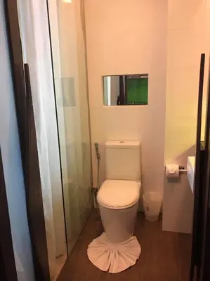 a small bathroom with a toilet and a mirror at The Beach by Glitter House in Kata Beach