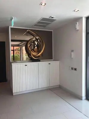 a large metal sculpture on a wall in a room at The Beach by Glitter House in Kata Beach