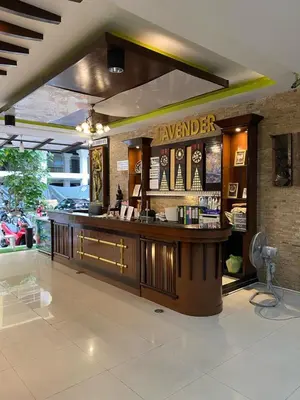 a restaurant with a bar in the middle of a room at Lavender Patong Hotel in Patong Beach