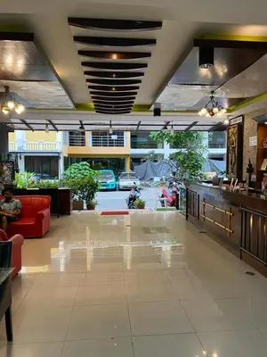 a lobby of a building with a lot of furniture at Lavender Patong Hotel in Patong Beach