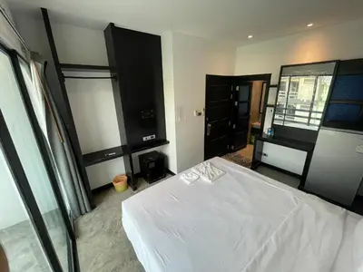 a bedroom with a large white bed in it at Cokoon Islanda Patong Hotel in Patong Beach
