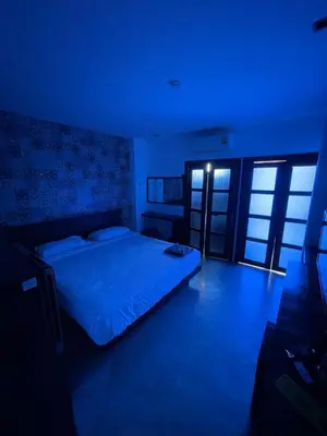 a bedroom with a bed in a blue room at Cokoon Islanda Patong Hotel in Patong Beach