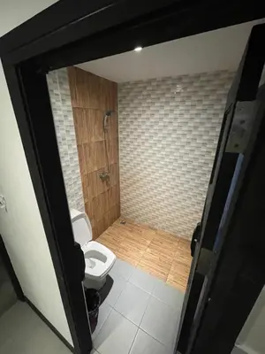 a bathroom with a toilet and a shower at Cokoon Islanda Patong Hotel in Patong Beach