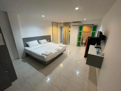 a bedroom with a bed and a flat screen tv at Cokoon Islanda Patong Hotel in Patong Beach