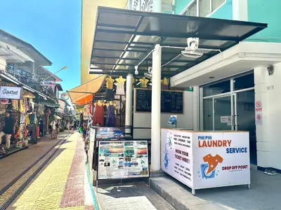 a shop with awning on the side of a street at Blue Flow Hostel in Phi Phi Don